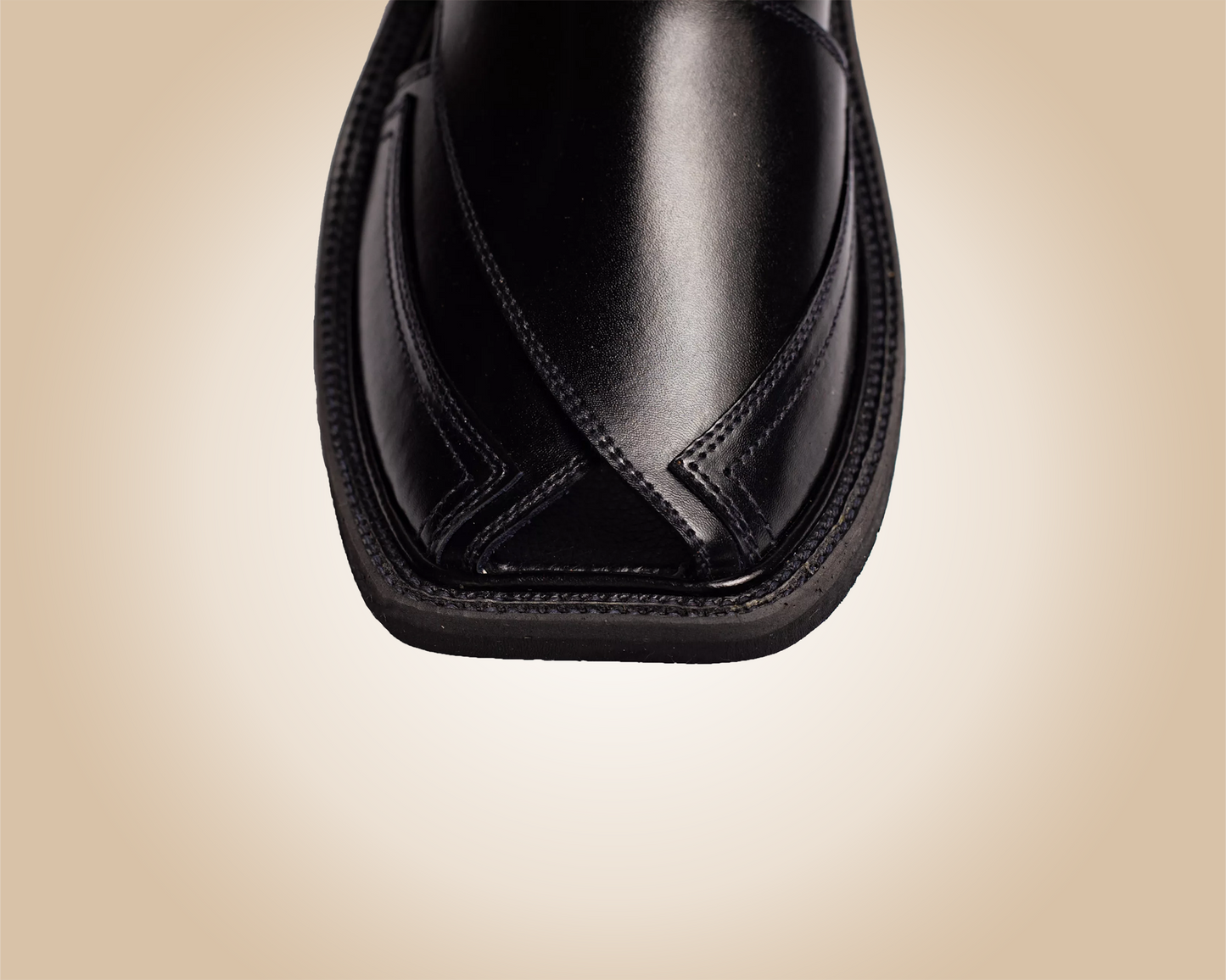 A pair of classic black Saplay sandals, known as Peshawari Chappal, with intricate leatherwork.